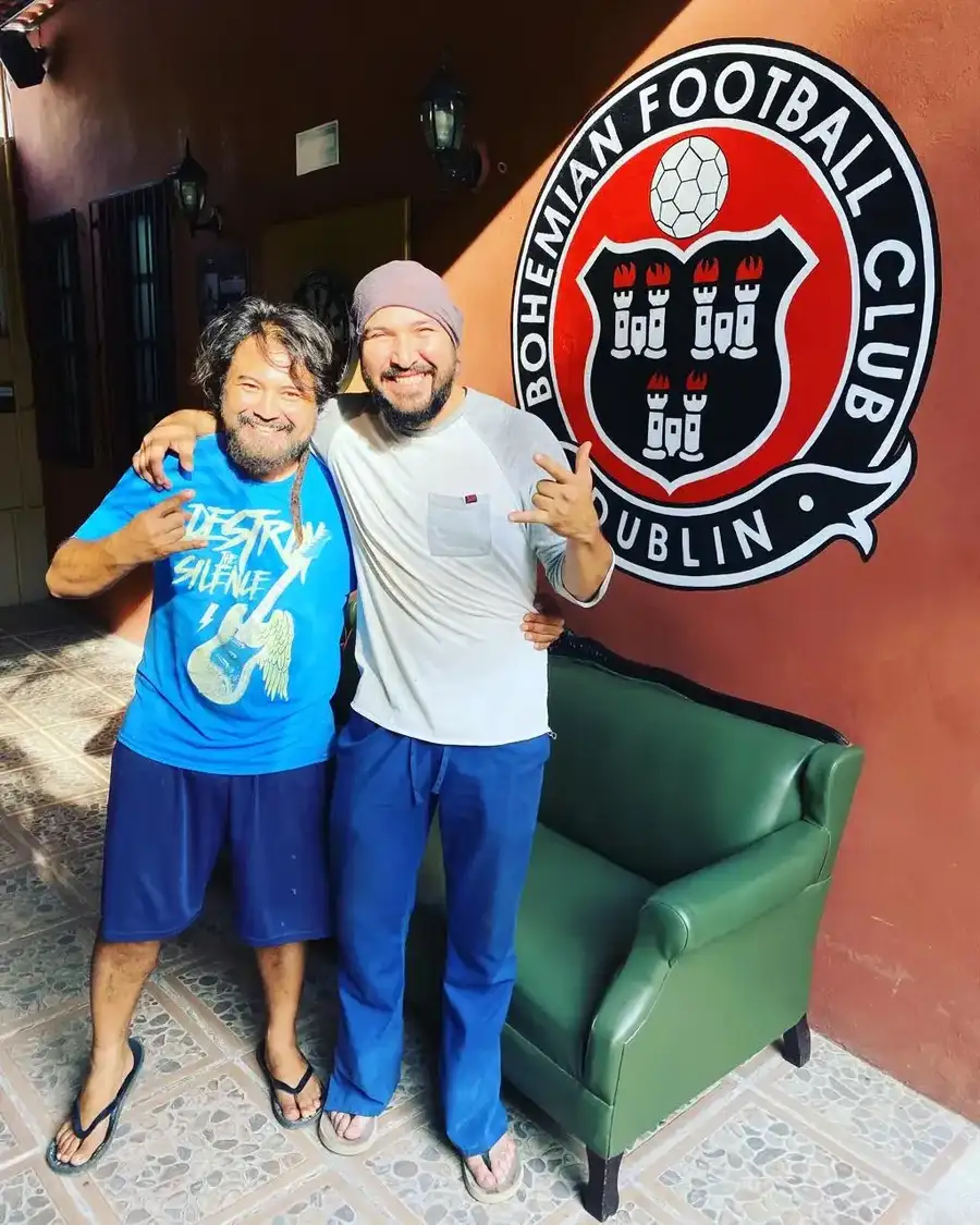 Reserved green chair beneath football signage at the pub
