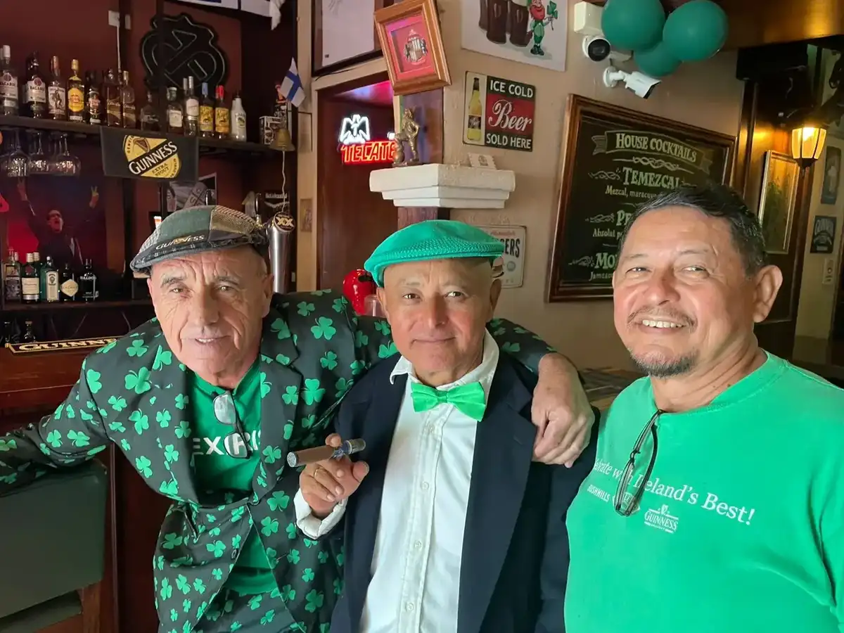 Mouse in the shamrock suit with friends at the bar in St Patrick's